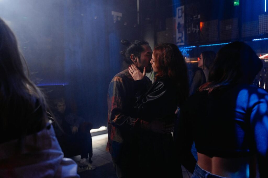 Couple kissing at a club