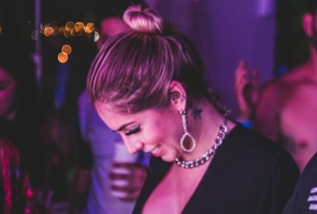 Woman smiling at the floor at a party