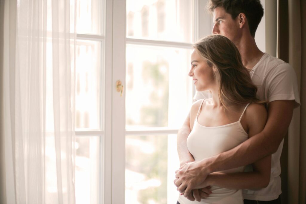 Tender couple cuddling in living room at home
