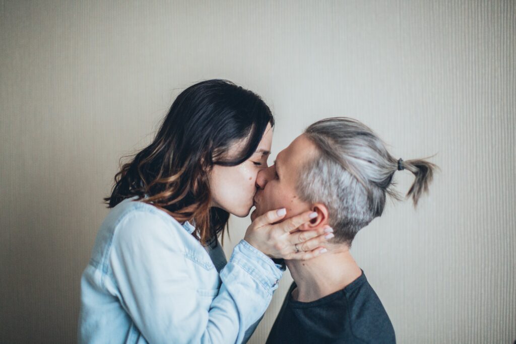 Polyamorous couple kissing