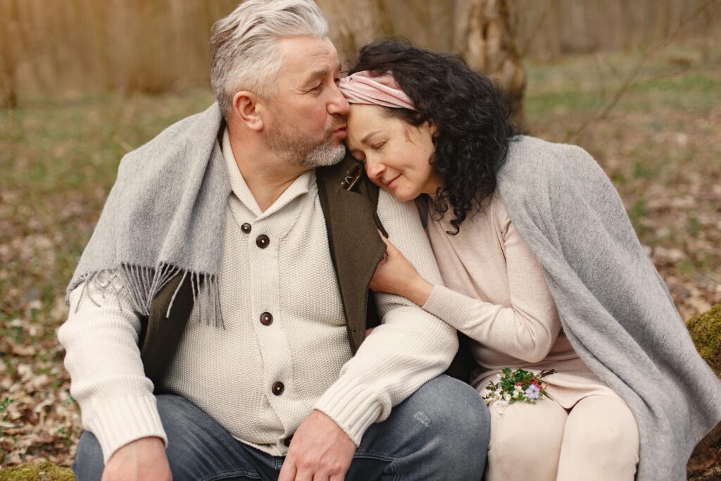 Happy senior couple hugging in autumn park

