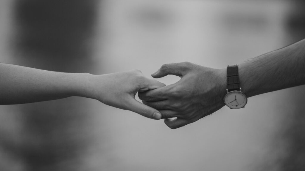Monochrome Photo of Couple Holding Hands
