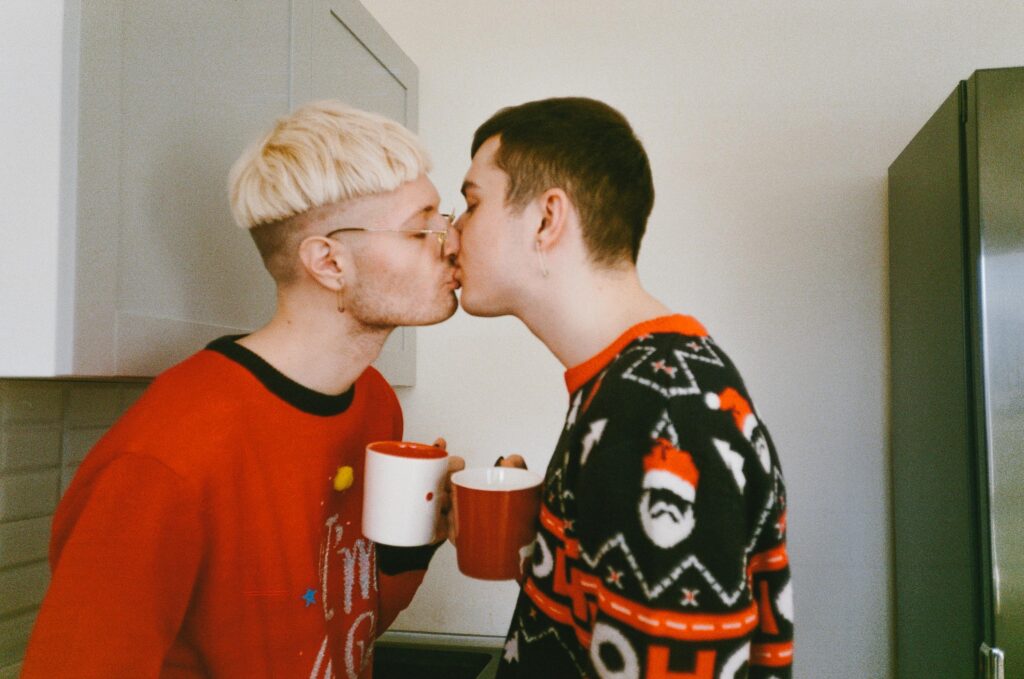 Polyamorous Men Wearing Sweater Kissing
