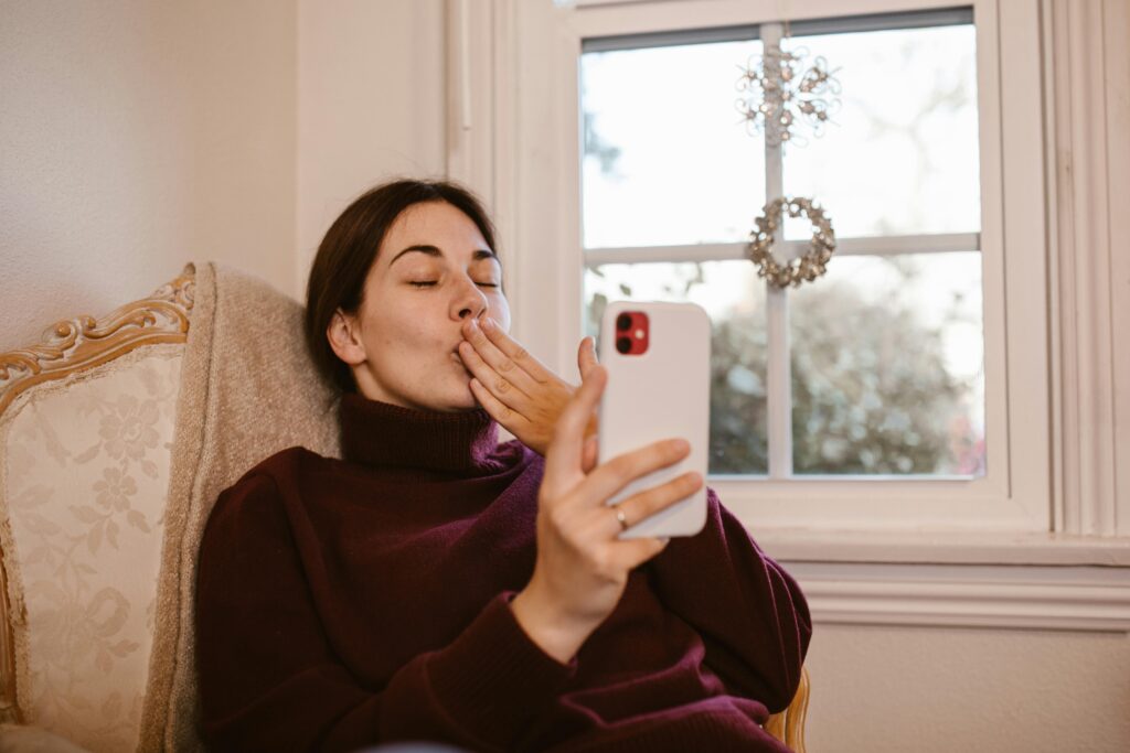 Woman Sitting on Chair while Having a Video Call
