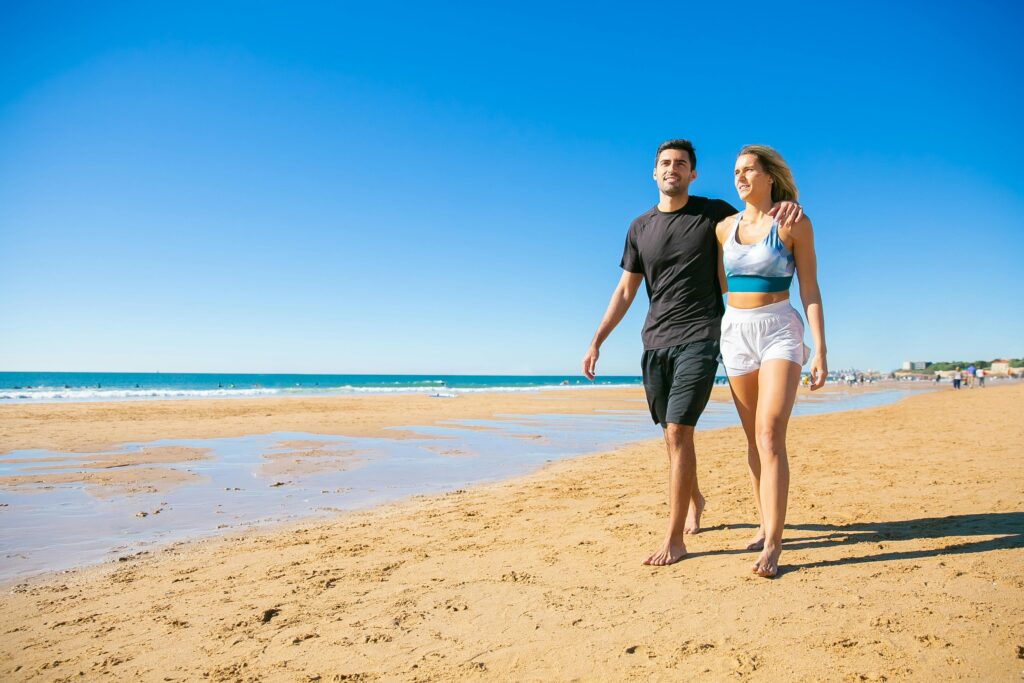 Polyamorous Couple Walking on the Shore