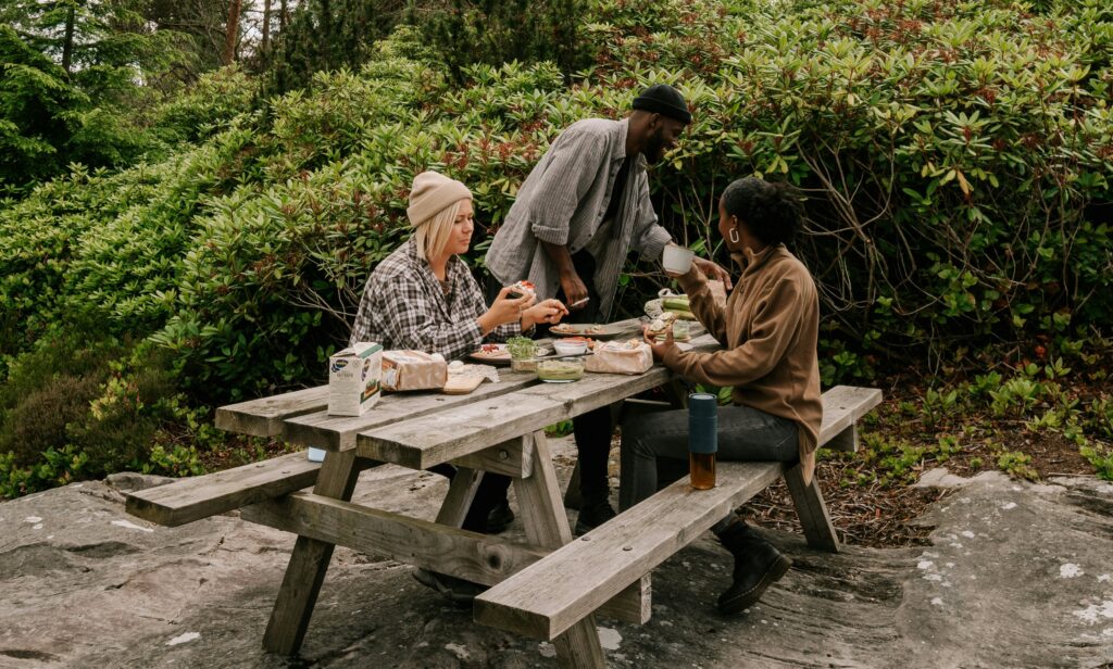 a group of people sitting at a picnic table