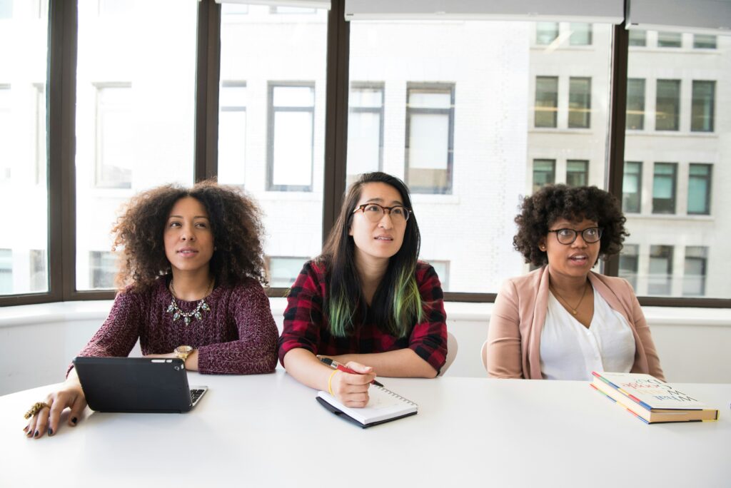 three women sitting with a laptop