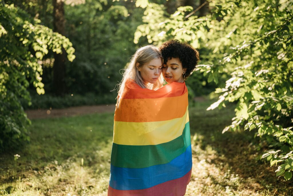 A Couple Wrapped with Rainbow Flag
