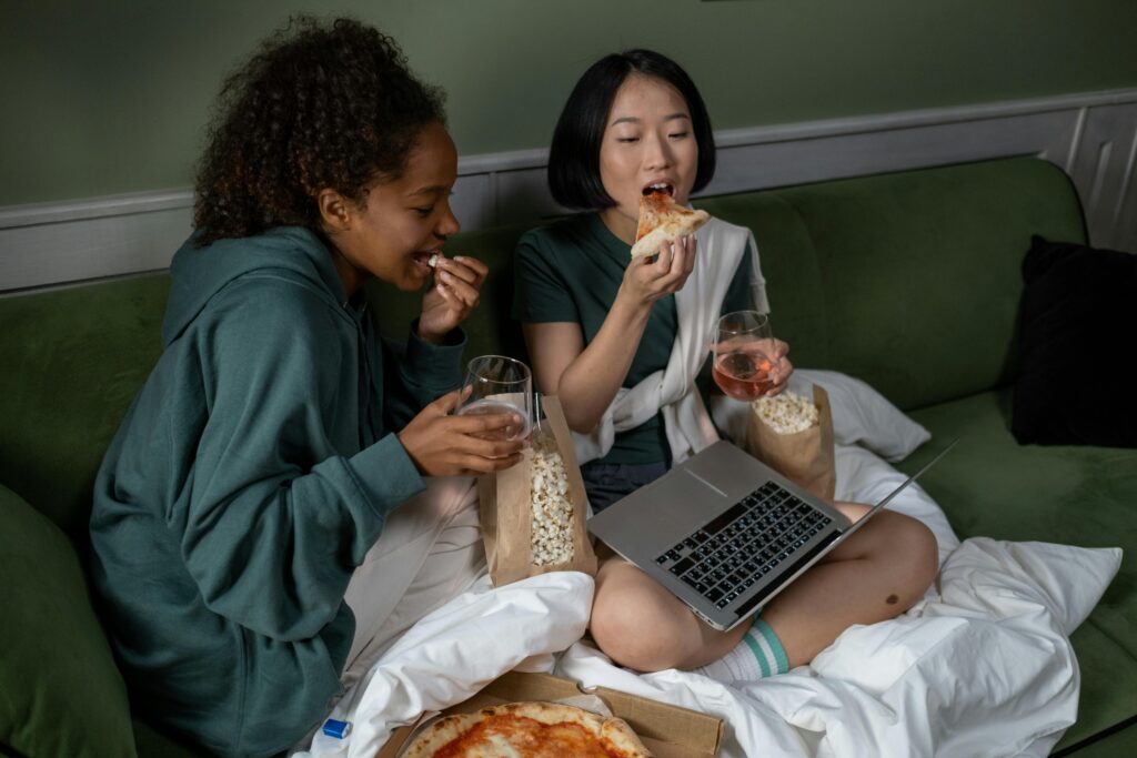 A Couple Watching on a Laptop while Eating
