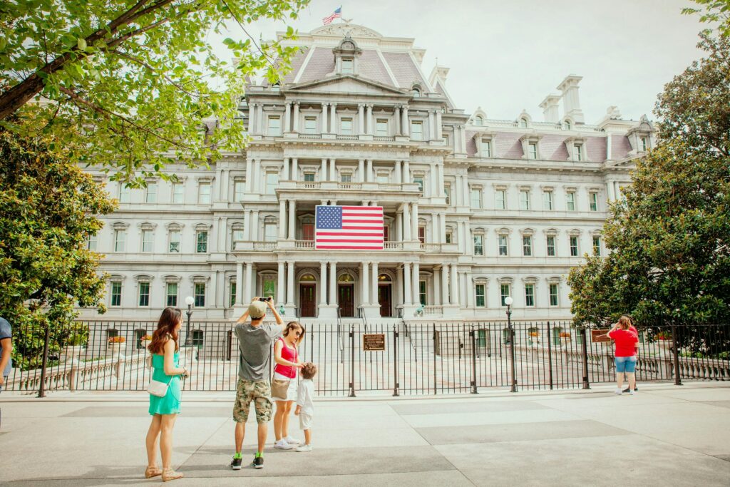 Photo of Group of People Near White Concrete Building White Flag of U.s.a.
