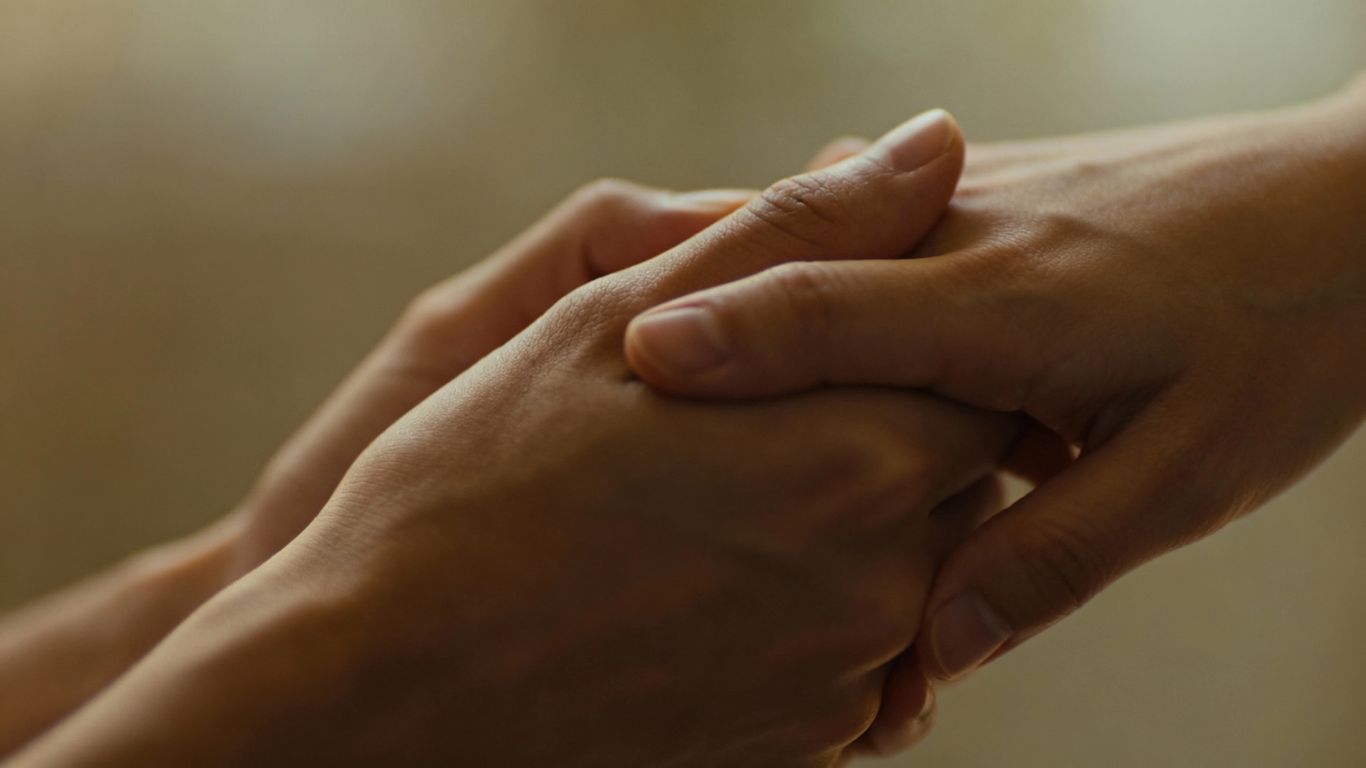 Hands intertwined, symbolizing trust and connection in relationships.